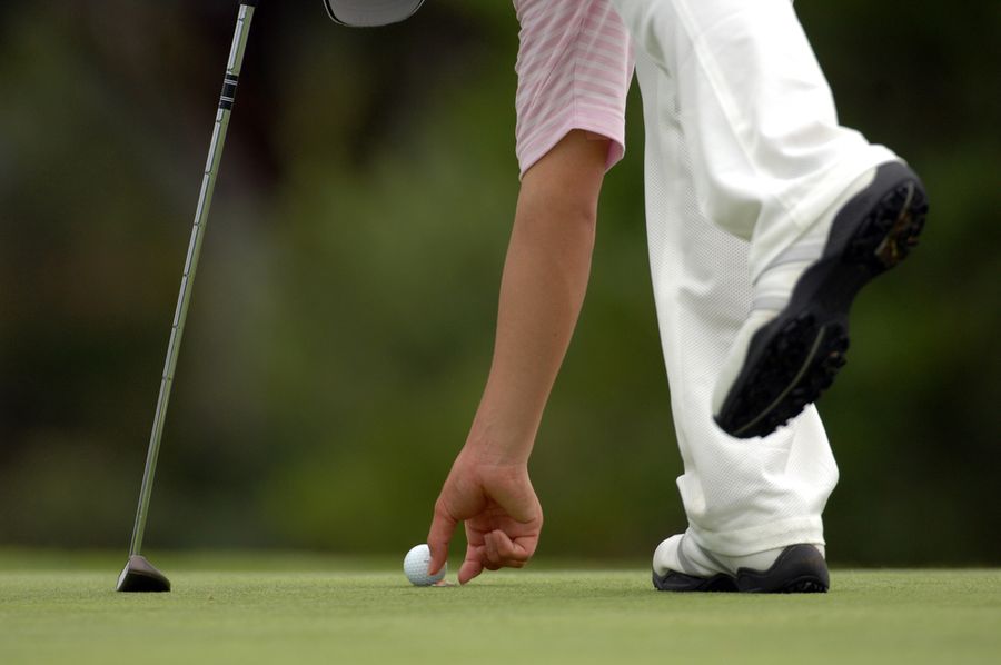 Tips on Golf Ball Markers and Creative Ways to Mark Your Balls 2 golfer marking ball
